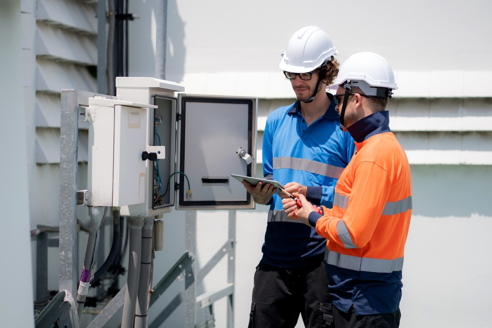Team,Engineer,Inspect,Electrical,Control,Panel,Using,Tablet,Checking,Voltage,